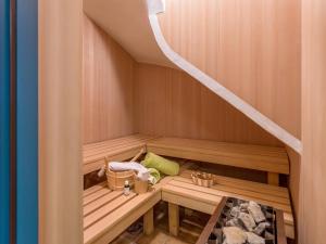a sauna with wooden benches and a staircase at Studio mit Sauna in Kirchberg in Tirol