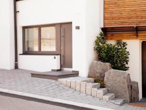 a front door of a house with some rocks at Studio mit Sauna in Kirchberg in Tirol +2 photos