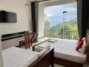 a room with a large window and a bed and a balcony at Verona Heights Ella in Ella