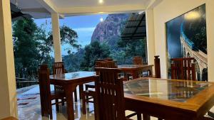 a restaurant with tables and chairs and a large window at Verona Heights Ella in Ella