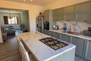 a kitchen with a table and a counter top at Three Cities Haven in Taʼ Penza