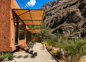 a group of benches sitting on the side of a building at Glaciar de Roca Lofts in Horcon