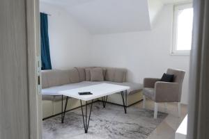 a living room with a couch and a table at Cherry Apartments in Sarajevo