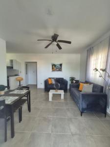 a living room with a couch and a ceiling fan at OMY Apartments Nagua 2A in Nagua