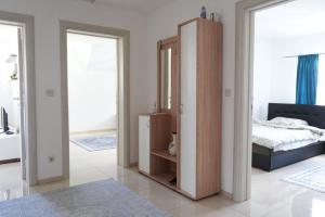 a bedroom with a bed and a large mirror at Cherry Apartments in Sarajevo