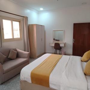 a bedroom with a large bed and a couch at دار الباحة فرع رقم 2 in Al Baha