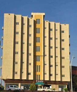 a large building with many windows in a parking lot at دار الباحة فرع رقم 2 in Al Baha