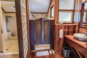 a bathroom with a sink and a toilet and a tub at Sutera Sanctuary Lodges At Kinabalu Park in Kampong Kundassan +81 photos