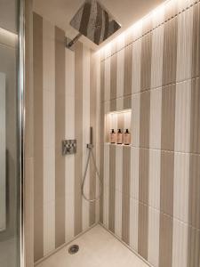 a bathroom with a shower with a shower head at 336 Saint-Honore By Chapitre Collection in Paris