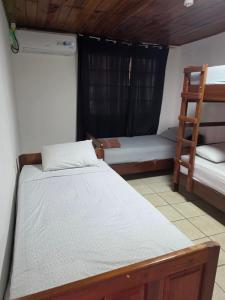 a bedroom with two bunk beds and a ladder at Casa solarte bocas del toro in Bluff BEach