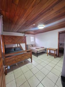 a room with two bunk beds and a table at Casa solarte bocas del toro in Bluff BEach