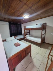 a room with two bunk beds and a table at Casa solarte bocas del toro in Bluff BEach