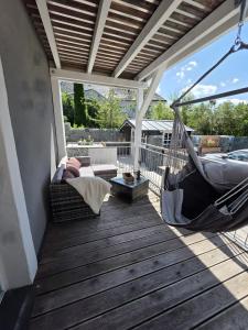 a porch with a hammock on a deck at Rosenzauber Seeromantik "Kramer" in Weißenstadt
