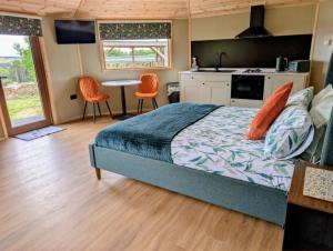 a bedroom with a bed and a table and chairs at West Wood Yurts Ltd in Newcastle upon Tyne