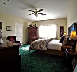 a bedroom with a bed and a ceiling fan at Bradford House Bed and Breakfast in Branson
