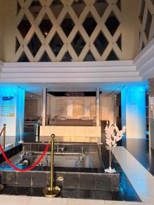 a room with a sink and a bed with a red ribbon at فندق قصر الكادي in An Nikāshah +22 photos