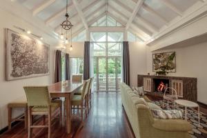 a dining room with a table and a fireplace at Sutera Sanctuary Lodges At Kinabalu Park in Kampong Kundassan