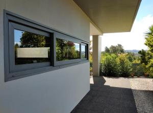a window on the side of a house at Single House in Vila Real +12 photos