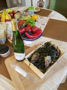a table with a bottle of wine and a box of vegetables at A&S Vidugiris in Jurbarkas +18 photos