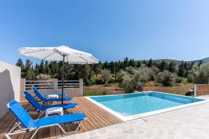a swimming pool with blue chairs and an umbrella and a swimming pool at Tsoutsis Villas in Marantochori