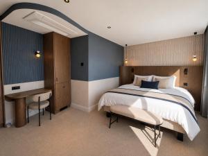 a bedroom with a large bed and a desk at 336 Saint-Honore By Chapitre Collection in Paris +8 photos
