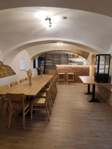 a large dining room with a long table and chairs at Statek u Juzů in Dolní Újezd