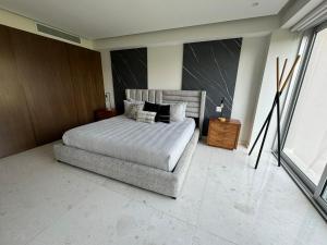 a bedroom with a bed and a large window at Departamento Brisa del Mar Punta Mita, Beach Front in Bucerías +33 photos