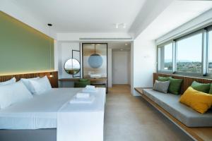 a bedroom with a large bed and a couch at Homey - a living space in Daratso