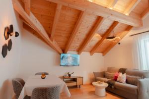 a living room with a couch and a table at Planat in San Cassiano