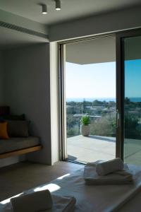 a bedroom with a large sliding glass door with a view at Homey - a living space in Daratso