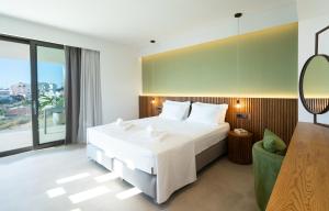 a bedroom with a large bed and a large window at Homey - a living space in Daratso