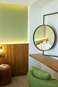 a room with a mirror and a green couch at Homey - a living space in Daratso +108 photos