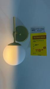 a light hanging from a ceiling with a sign on it at Apto no centro in Nova Mutum