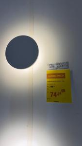 a light on a wall with a sign on it at Apto no centro in Nova Mutum