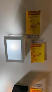 a microwave oven with some boxes on the wall at Apto no centro in Nova Mutum