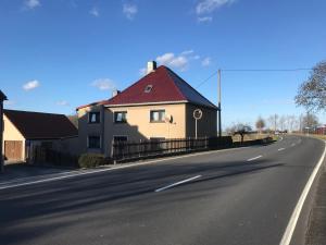 a house with a red roof on the side of a road at Landhaus Oma Gretel - Nossen, Siebenlehn, Freiberg, Meißen, Dresden, Chemnitz 
