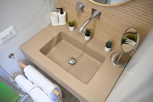 a bathroom sink with plants and a mirror at Kleos Luxury Rooms in Porto Empedocle +12 photos