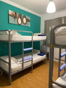 two bunk beds in a room with a blue wall at Valença Guesthouse in Valença +33 photos