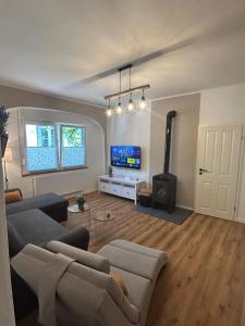 a living room with a couch and a tv at Alte Schmiede Karden in Treis-Karden