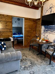 a living room with a couch and a table at Detlafówka Kaszubski Resort in Dębki