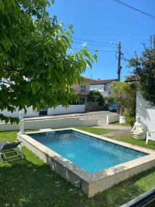a swimming pool in the backyard of a house at Valença Guesthouse in Valença