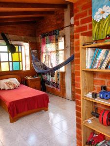 a bedroom with a bed and a hammock in a room at Apartaestudio amoblado in Jamundí