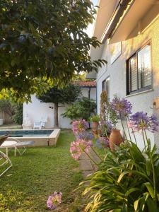 a garden with flowers and a swimming pool at Valença Guesthouse in Valença