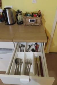 a table with a drawer full of kitchen utensils at Friendly Footprint in Golden