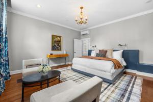 a bedroom with a bed and a couch and a table at The Germantown Inn in Nashville