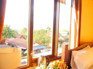 a kitchen window with a view of a city at Camellia Vang Vieng in Vang Vieng