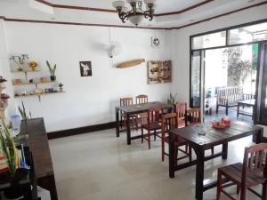 a dining room with wooden tables and chairs at Camellia Vang Vieng in Vang Vieng
