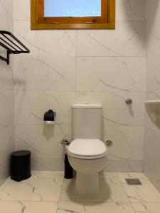 a white bathroom with a toilet and a sink at El Bawaba Lodge & Luxury Retreat in Luxor +47 photos
