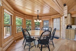 a dining room with a table and chairs at Fiddler Lake Resort - Deer 48 in Mille-Isles