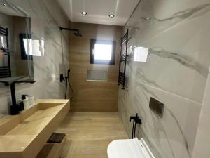 a bathroom with a sink and a toilet at Villa zhara in Bizerte